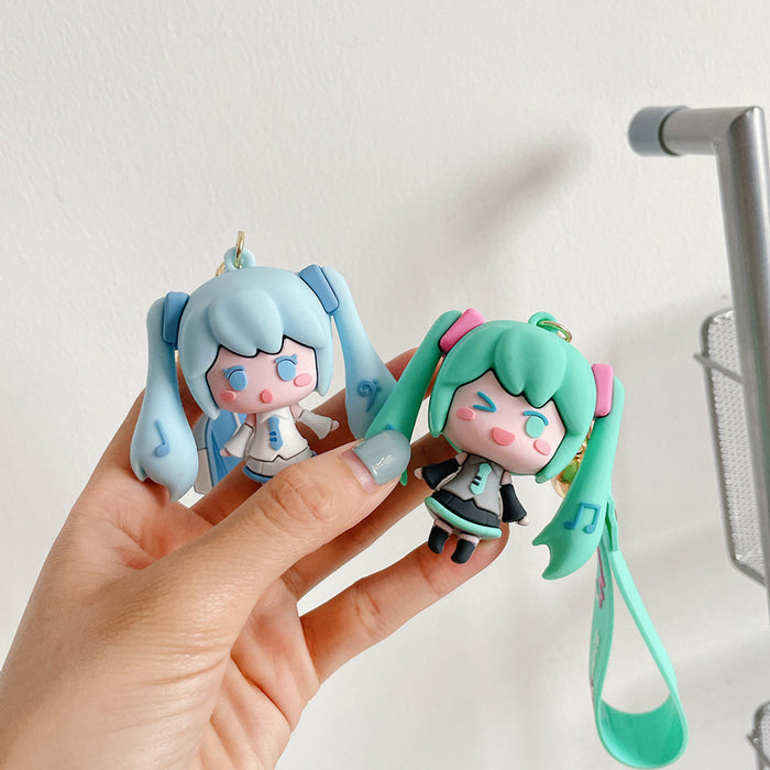 Adorable Miku Keychains with Pastel Charm: light blue, white anime-style girl character with long twin-tail blue hair, kawaii