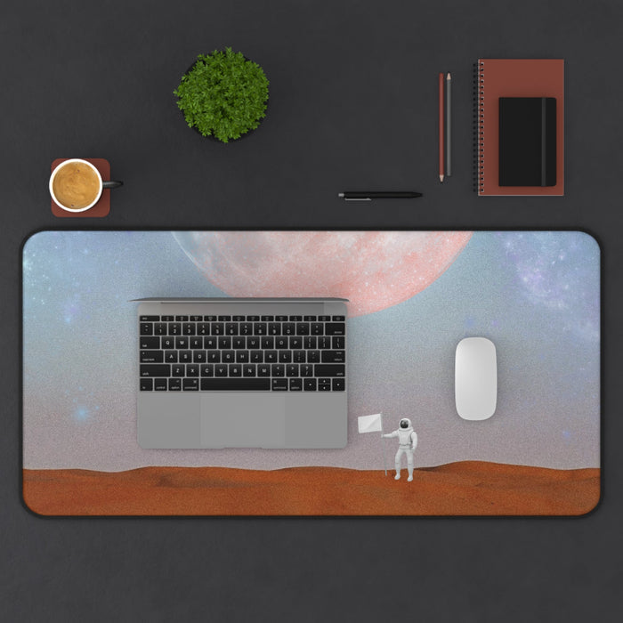Astronaut's Arrival on Planet X Mouse Pad Desk Mat: blue-gray, pink astronaut on a moonlike landscape beneath a large planet