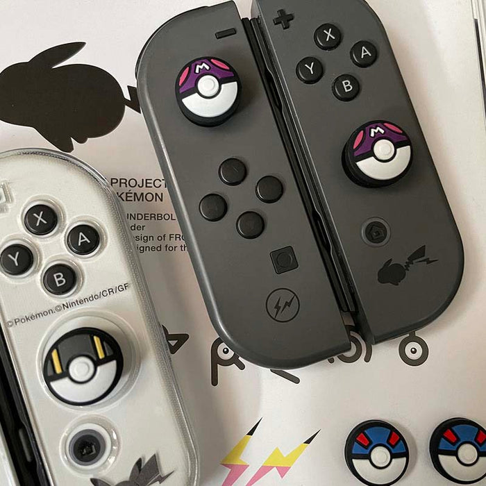 Ball Switch Thumb Grips for Switch: black, white Poké Ball-like design, cartoon-inspired minimal style
