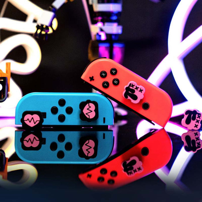 Black n Pink Switch Thumb Grips: turquoise blue, coral red cartoon bunny-like character graphic