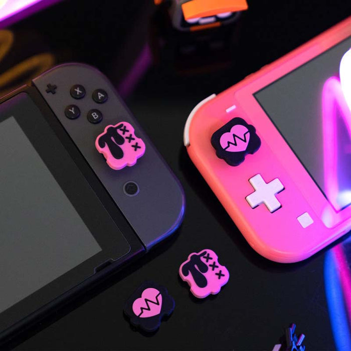 Black n Pink Switch Thumb Grips: turquoise blue, coral red cartoon bunny-like character graphic