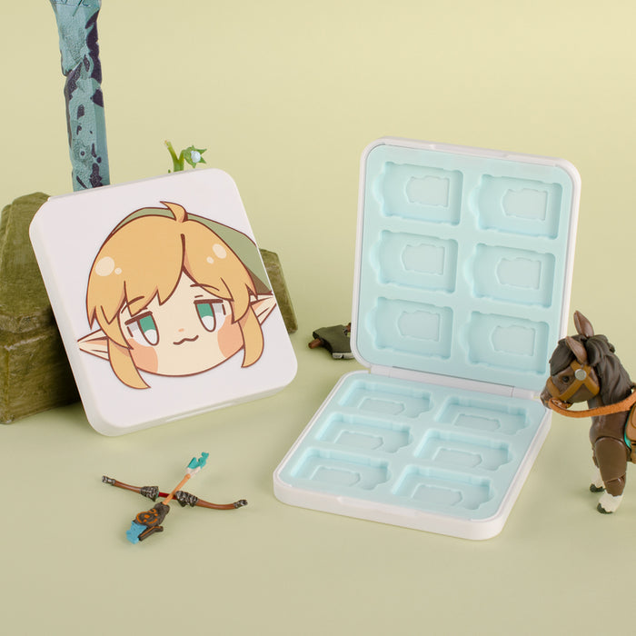 Chibi Link Game Card Case: pale pink, light blue cartoon elf-like character and small green creature, kawaii cartoon style