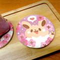 Cute Coasters with Chibi Pokemon design: pink, purple cartoon bunny character with flowers and heart, kawaii cartoon style