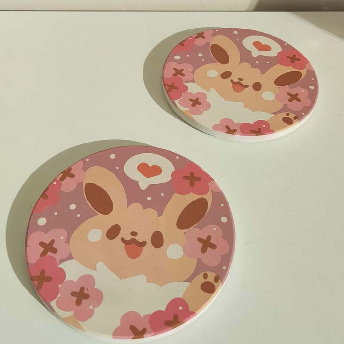 Cute Coasters with Chibi Pokemon design: pink, purple cartoon bunny character with flowers and heart, kawaii cartoon style