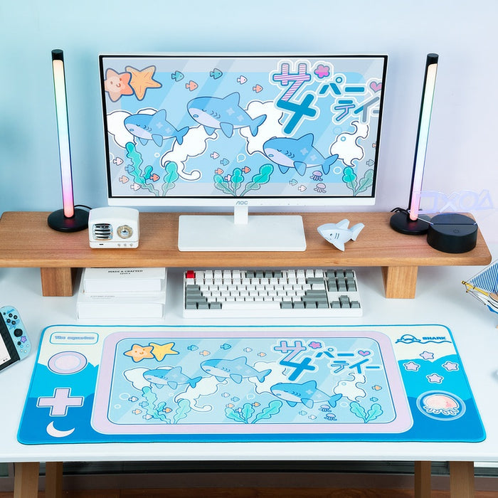 Cute Shark Gaming Desk Mat with Ocean Vibes: cyan blue, white cartoon sharks and sea-themed characters, kawaii cartoon style