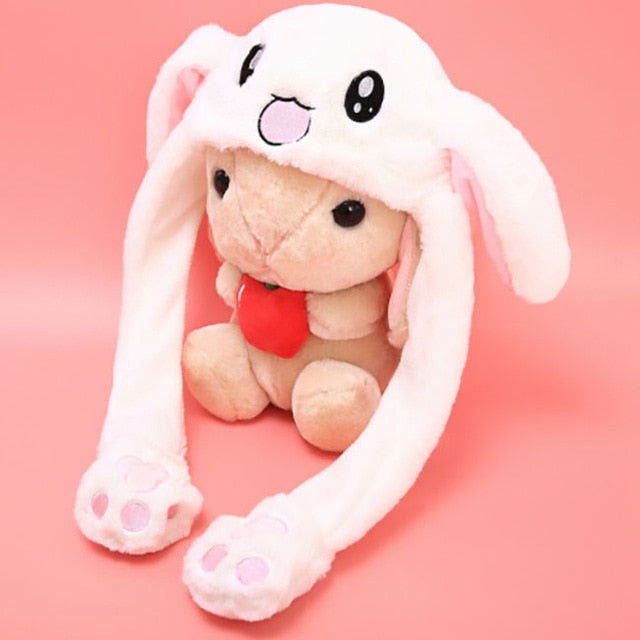 Dancing Bunny Hat with Moving Ears: white, light beige bear wearing a bunny hat, kawaii cartoon style