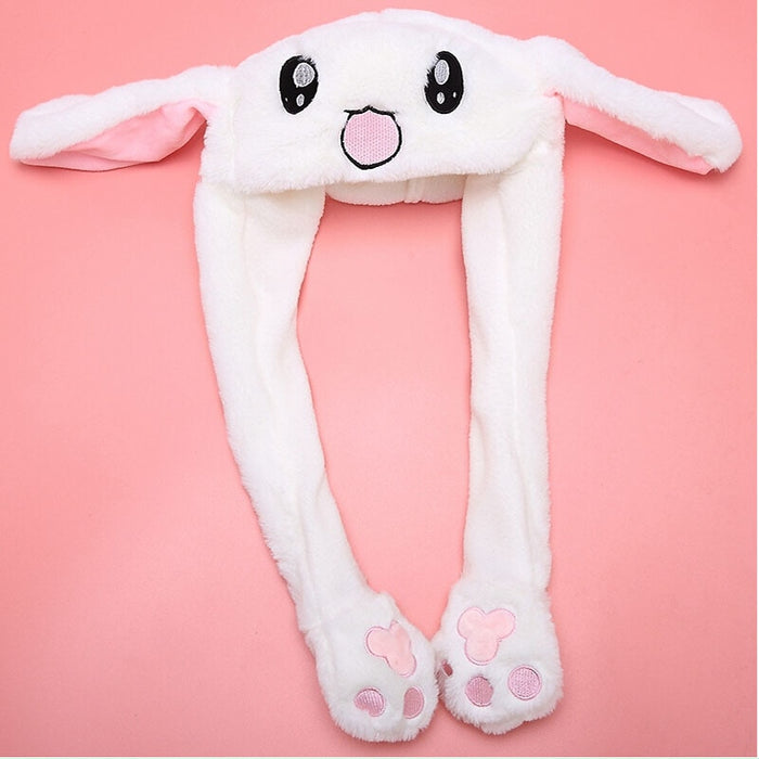 Dancing Bunny Hat with Moving Ears: white, light beige bear wearing a bunny hat, kawaii cartoon style