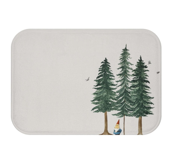 Forest Dweller Gnome Home Accents Bath Mat: off-white, dark green evergreen trees and a small gnome, illustrated woodland sty