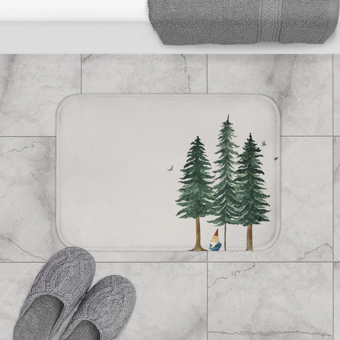 Forest Dweller Gnome Home Accents Bath Mat: off-white, dark green evergreen trees and a small gnome, illustrated woodland sty