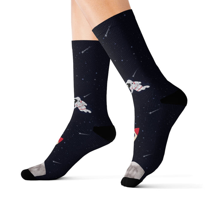 Funny Novelty Socks for Space Enthusiasts: dark navy, black space theme with astronauts and rocket, cartoon space-themed styl
