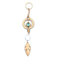 Genshin Impact Scaramouche Keychain: Glowing Vision: gold, turquoise ornamental feather motif, ornamental fantasy style