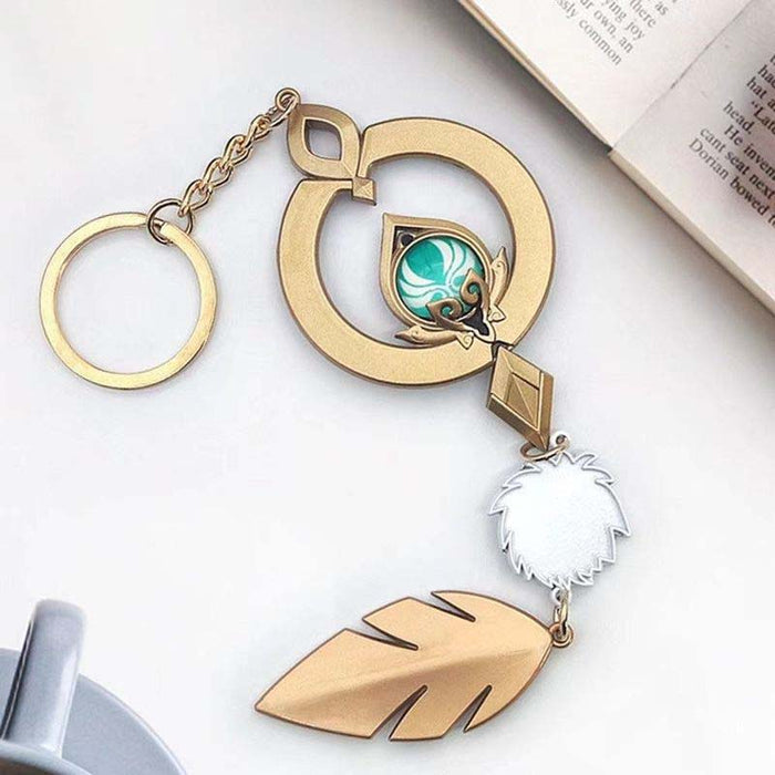 Genshin Impact Scaramouche Keychain: Glowing Vision: gold, turquoise ornamental feather motif, ornamental fantasy style