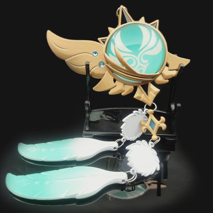 Genshin Impact Venti Vision Keychain: glowing turquoise green, brown fantasy winged emblem with feather charms, fantasy carto