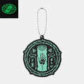 Glow in the Dark Zelda Keychains: black, mint green stylized mystical eye and hand symbol, graphic, occult-inspired, cartoon