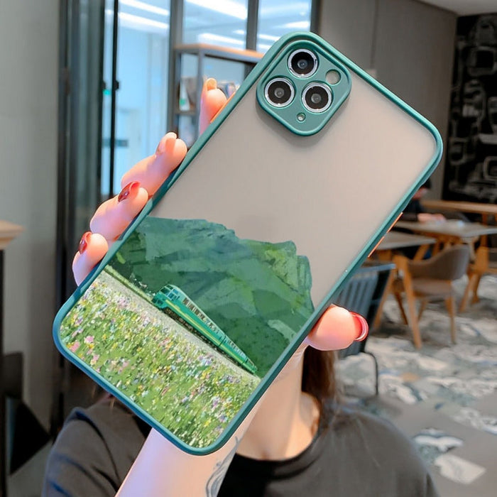iPhone Cartoon Theme Phone Case: A Playful Cover for Your Device: light green, gray mountain landscape, illustrated scenic la