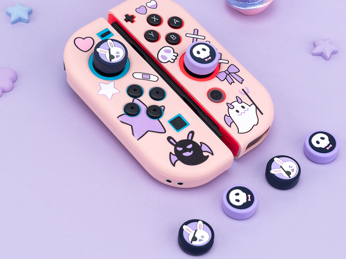 Kawaii Animal Design Switch Thumb Grips: pastel pink, black bunny and skull/cartoon character theme, kawaii cartoon style