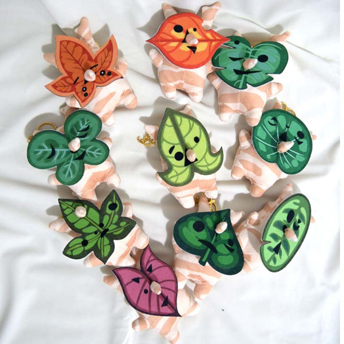 Korok Plushies with Interchangeable Faces and Sound: green, orange cartoon orange animal character with green leaf characters