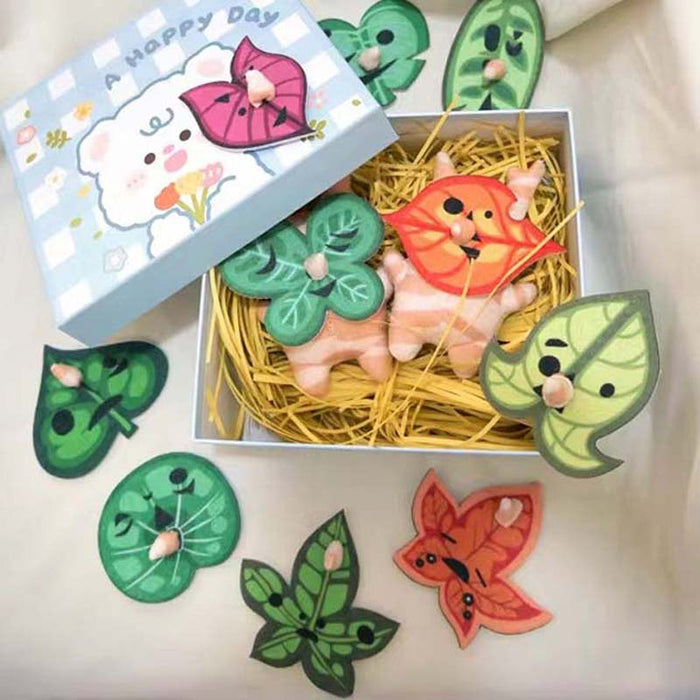 Korok Plushies with Interchangeable Faces and Sound: green, orange cartoon orange animal character with green leaf characters