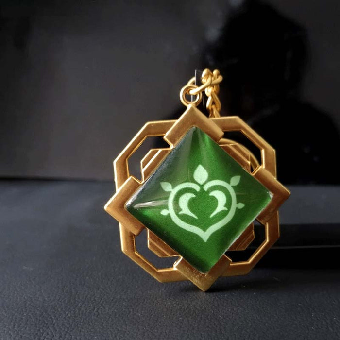 Liyue Vision Key Chain: Genshin Impact: gold, teal stylized white floral/crest emblem, fantasy-inspired geometric style