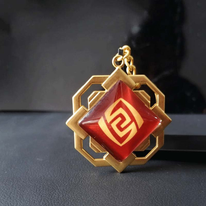 Liyue Vision Key Chain: Genshin Impact: gold, teal stylized white floral/crest emblem, fantasy-inspired geometric style