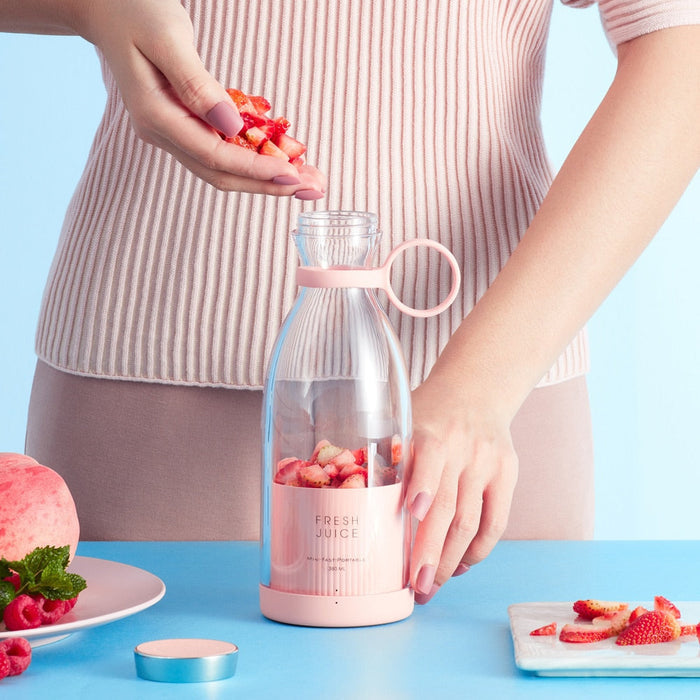 Mobile Blender for Juicing On-the-Go: pale yellow-green, clear fruit juice, modern minimal style