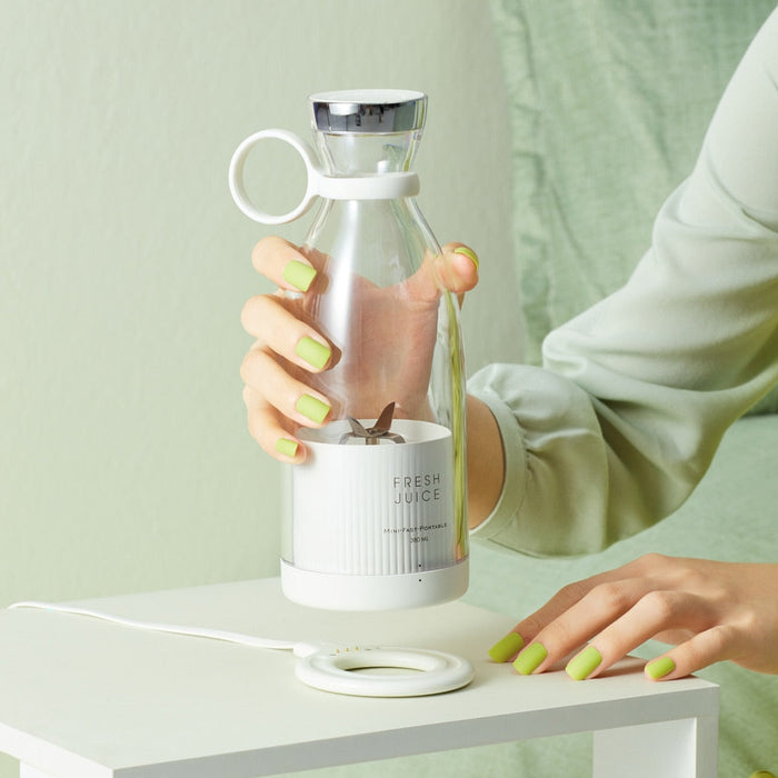 Mobile Blender for Juicing On-the-Go: pale yellow-green, clear fruit juice, modern minimal style