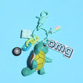 Pokemon Lover Keychain with Accessories: teal, yellow Squirtle-like turtle character, cartoon style