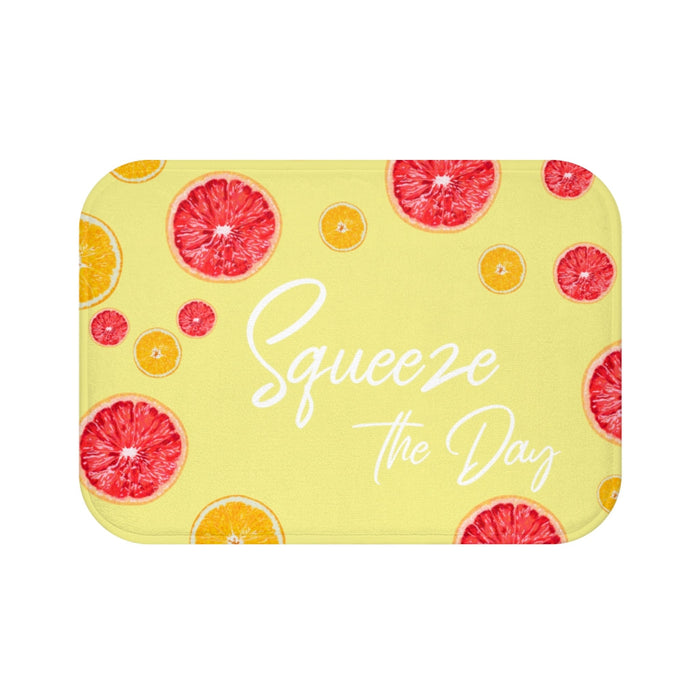 Squeeze the Day Citrus Bath Mat: light yellow, red-pink citrus fruit theme, bright playful graphic style