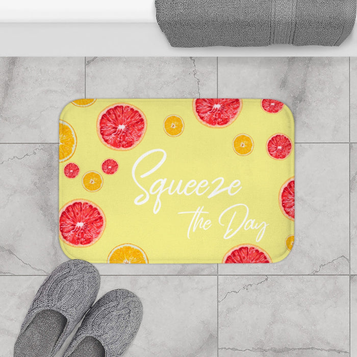 Squeeze the Day Citrus Bath Mat: light yellow, red-pink citrus fruit theme, bright playful graphic style