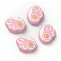 Switch Thumb Grips with Angel Wings: pink, white stylized winged emblem with star, kawaii cartoon style