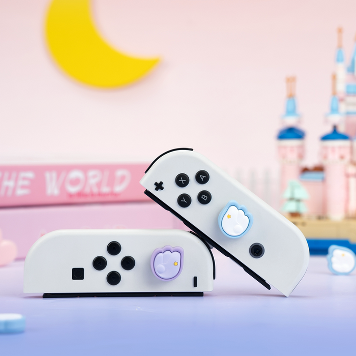 Switch Thumb Grips with Angel Wings: pink, white stylized winged emblem with star, kawaii cartoon style