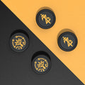 Zelda Joystick Caps with Sheikah Slate: black, gold/yellow stylized symbols/emblems, minimal graphic, game-token-like style