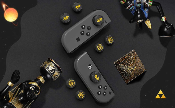 Zelda Joystick Caps with Sheikah Slate: black, gold/yellow stylized symbols/emblems, minimal graphic, game-token-like style