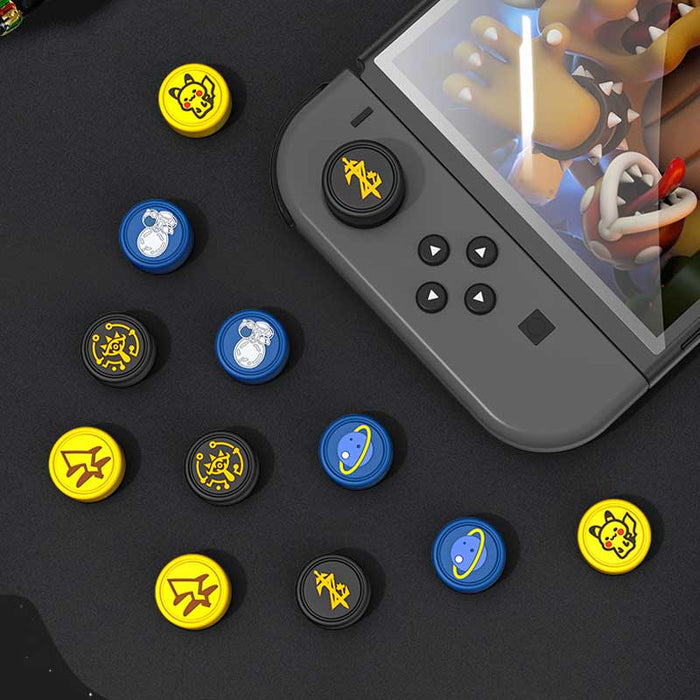 Zelda Joystick Caps with Sheikah Slate: black, gold/yellow stylized symbols/emblems, minimal graphic, game-token-like style
